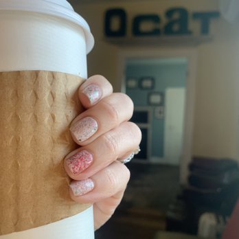 Orange Cat Coffee Co - a hand holding a coffee cup - Coffee & Tea Near Me - Lewiston, New York