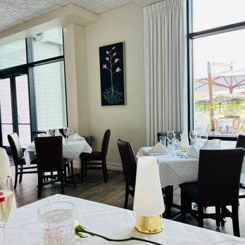 Ambrosia - a dining room with tables and chairs - Steakhouses Near Me - Watersound, Florida Ambrosia - a dining room with tables and chairs - Steakhouses Near Me - Watersound, Florida