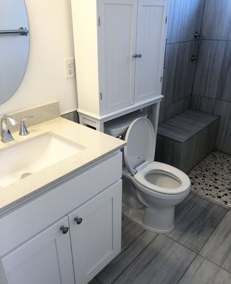 Handicap accessible bathroom remodel - This bathroom was remodeled to allow wheelchair access into the shower area. We removed the damn and build a roll in shower with grab bars and a bench. We flowed the tile throughout the bathroom to create a spa-like wet room. Handicap accessible bathroom remodel - This bathroom was remodeled to allow wheelchair access into the shower area. We removed the damn and build a roll in shower with grab bars and a bench. We flowed the tile throughout the bathroom to create a spa-like wet room.