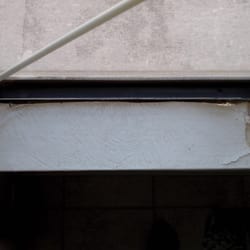 Decaying wallpaper. Broken window had to be propped up with a stick.