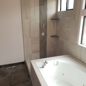 Anchor Tile - a bathroom with a large bathtub - Flooring Near Me