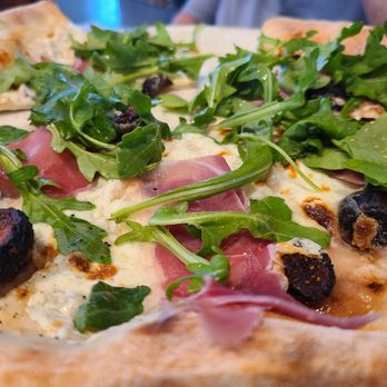 Sixty Vines - Fig and prosciutto pizza (white sauce, mozzarella, honey, arugula, sesame seeds) - New American Near Me - Charlotte, North Carolina Sixty Vines - Fig and prosciutto pizza (white sauce, mozzarella, honey, arugula, sesame seeds) - New American Near Me - Charlotte, North Carolina