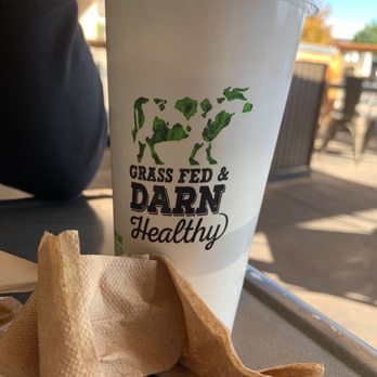 Grassburger - a cup of milkshake and a napkin on a table - Burgers Near Me - Albuquerque, New Mexico