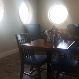 a dinning room with four round windows a dinning room with four round windows
