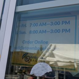 a woman with an umbrella in front of a window a woman with an umbrella in front of a window