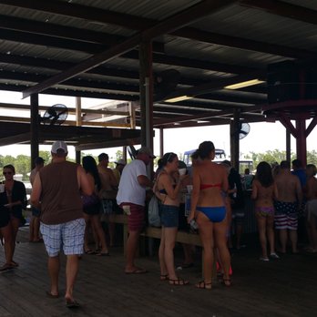 Prop Stop Inn - a group of people standing on a dock - Bars Near Me - Springfield, Louisiana