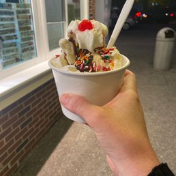 a hand holding a cup of ice cream