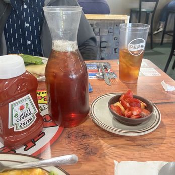 Jus Grill Restaurant - I got a side of fruit and Julia brought a carafe of iced tea. - American Near Me - Aurora, Colorado