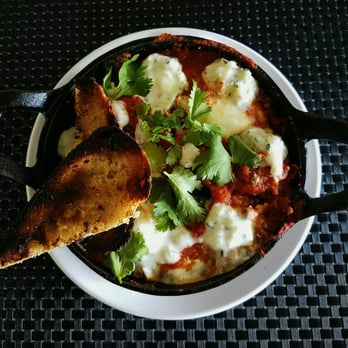 Trust - Baked Eggs | Moroccan Sauce | Peppers | Tomatoes | Tzatziki | Kale | Chickpeas | Wood Grilled Bread - New American Near Me - San Diego, California
