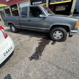My truck with oil pouring out of it.
