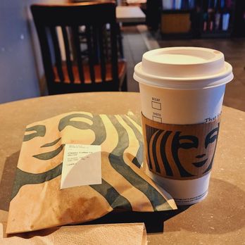 Starbucks - a cup of coffee and a paper bag on a table - Coffee & Tea Near Me - Columbus, Ohio