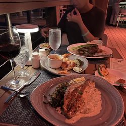 Red snapper grilled and far plate ribeye steak.