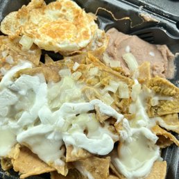 Chilaquiles. Raw onions--too big! Spicy!!