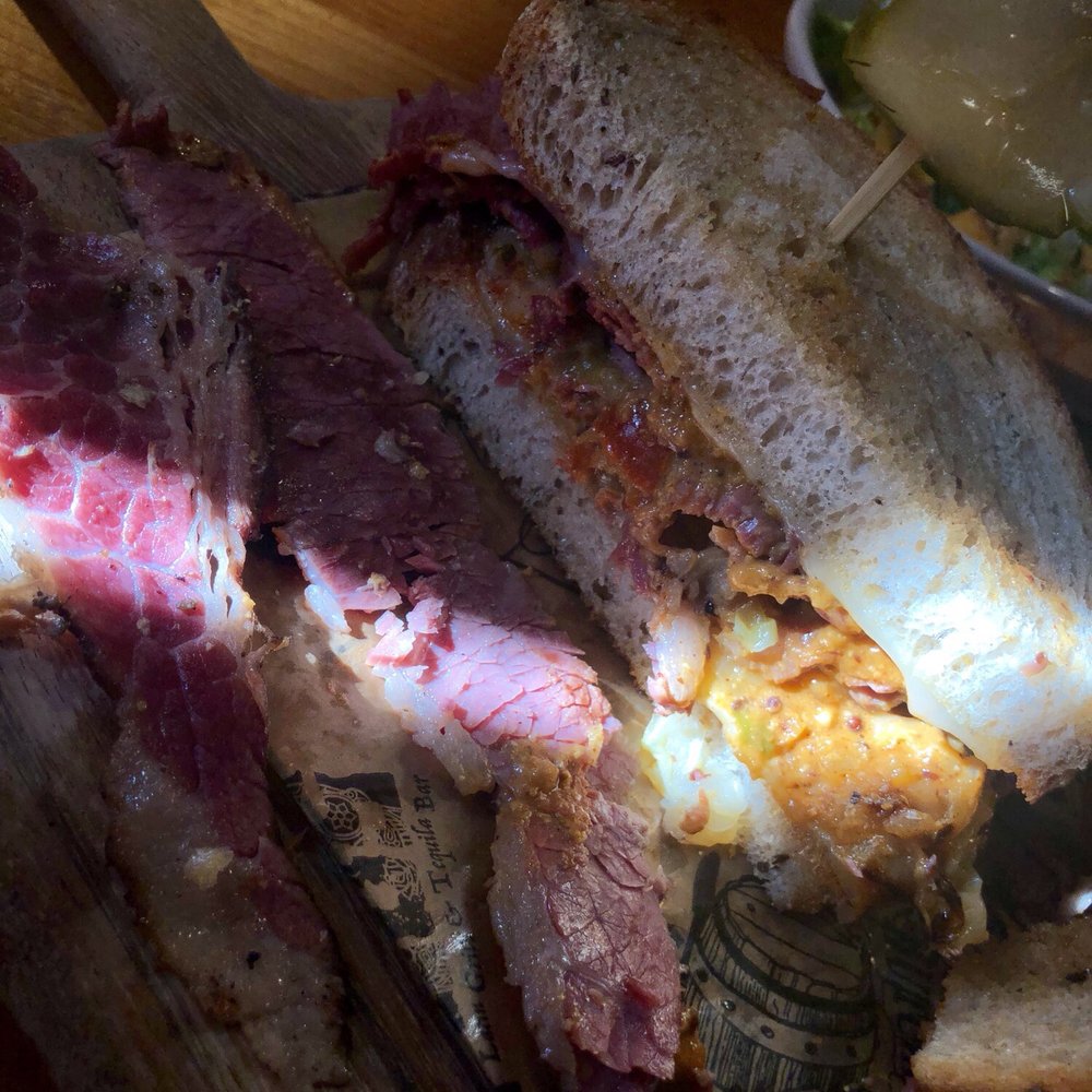 Bourbon & Butcher - Piece of pastrami on left and corned beef on right and 1/2 a Ruben. - Bars Near Me - Mishawaka, Indiana Bourbon & Butcher - Piece of pastrami on left and corned beef on right and 1/2 a Ruben. - Bars Near Me - Mishawaka, Indiana
