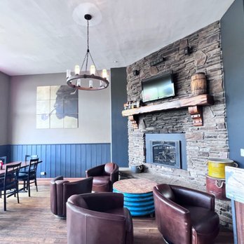 Brickhouse 40 - a living room with a stone fireplace - American Near Me - Granby, Colorado Brickhouse 40 - a living room with a stone fireplace - American Near Me - Granby, Colorado