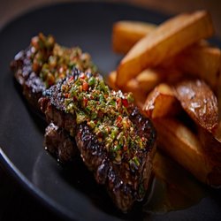 Casa Leeds - Succulent Solomillo (sirloin steak) cooked to perfection for your enjoyment.
A large glass of Argentinian Malbec, the ideal accompaniment