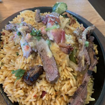 Applebee's Grill + Bar - Compare this to their menu photo of fajitas. A huge pile of rice with a few slices of meat. This would get you run out of town in Texas. - Sports Bars Near Me - Oak Ridge, Tennessee
