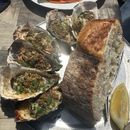 Baked oysters with a generous piece of delicious garlic bread. Baked oysters with a generous piece of delicious garlic bread.