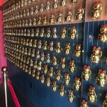 Miss Wong - Interesting wall of lucky cats - Cocktail Bars Near Me - Laval, Quebec