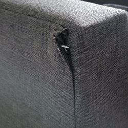 Leon's Furniture Store - Corner of one piece of the sectional peeled back....likely is what damaged the wall
