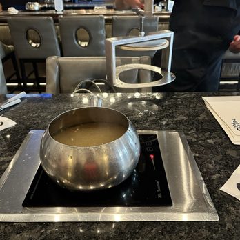 The Melting Pot - The gadget that the broth comes To the table in. Protects everybody from spills and getting burned - Fondue Near Me - Orlando, Florida The Melting Pot - The gadget that the broth comes To the table in. Protects everybody from spills and getting burned - Fondue Near Me - Orlando, Florida