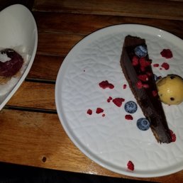 Dessert was chocolate tart with passion fruit sorbet. It was decadent and delicious Dessert was chocolate tart with passion fruit sorbet. It was decadent and delicious