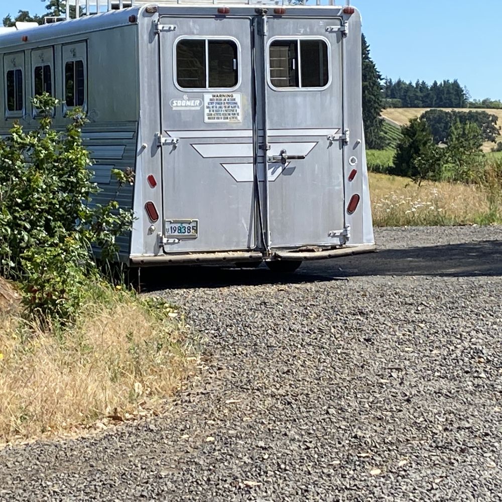 a horse trailer parked on the side of the road a horse trailer parked on the side of the road