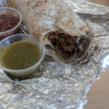 Burritos Express - A delicious few bites bitten al pastor burrito with the sauce on the side - Latin American Near Me - Paso Robles, California