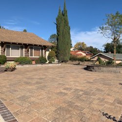 Pavers in the driveway and small round planter