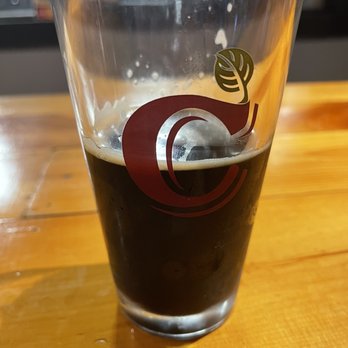 Chapman's Brewing Company - a pint glass on a wooden table - Breweries Near Me - Angola, Indiana Chapman's Brewing Company - a pint glass on a wooden table - Breweries Near Me - Angola, Indiana