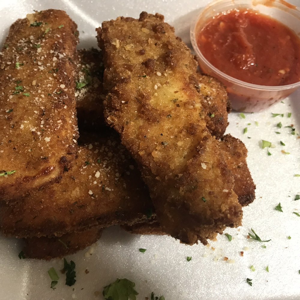 Mozzarella Sticks stacked with a side of marinara sauce Mozzarella Sticks stacked with a side of marinara sauce