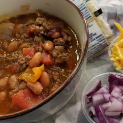 Pub'n Grub - Homemade Bowl of Chili with cheese and onions on the side.