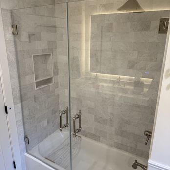 Superior Glass and Mirror - Beautifully installed dual-pivot frameless glass shower doors with polished nickel hardware and hinges to match existing shower trim. - Glass & Mirrors Near Me Superior Glass and Mirror - Beautifully installed dual-pivot frameless glass shower doors with polished nickel hardware and hinges to match existing shower trim. - Glass & Mirrors Near Me