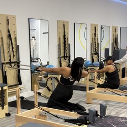 Instructor showcasing the technique. Reformer Fit Club