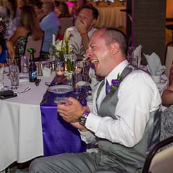 Rakis Productions - Guests Laughing at personalized wedding bios done by Nikos Rakis of Rakis Productions.