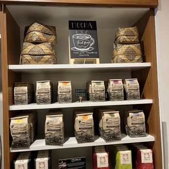Cloudforest Coffee - Coffee - Shelves in a coffee shop display various coffee bags labeled 'Cloud Forest Coffee' and tea boxes, with a sign indicating Tanzanian chocolate mocha. - Coffee & Tea Near Me - Ottawa, Ontario