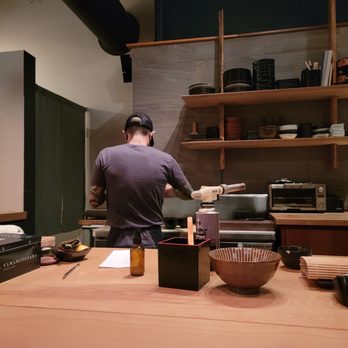 Nimblefish - a man preparing food in a kitchen - Sushi Bars Near Me - Portland, Oregon