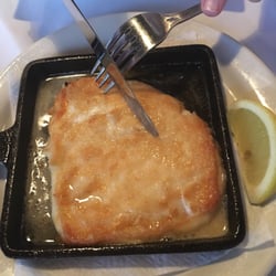 Cutting into the Saganaki at Mythos.