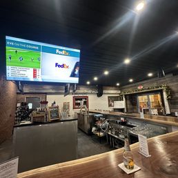 a bar with a large screen a bar with a large screen