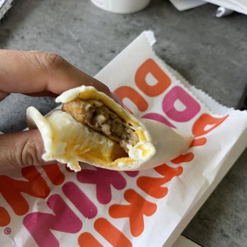 Dunkin Donuts - a hand holding a burrito - Coffee & Tea Near Me - Brighton, Michigan Dunkin Donuts - a hand holding a burrito - Coffee & Tea Near Me - Brighton, Michigan