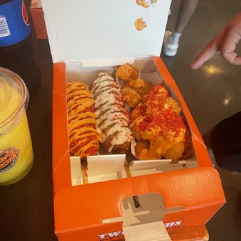 Two Hands Corn Dogs - Spicy dog with hot cheeto crumbs and their sauce, the two hand dog and the tat or tots with same sauce and hot cheeto crumbs... VERY YUM - Hot Dogs Near Me - Houston, Texas