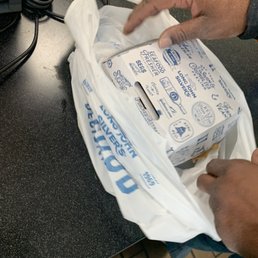a man holding a bag of food a man holding a bag of food