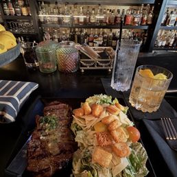 Steak and Caesar salad. Peach old fashioned. Steak and Caesar salad. Peach old fashioned.