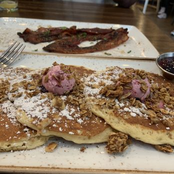 First Watch - Lemon blueberry multi grain pancakes with a side of million dollar bacon - Breakfast & Brunch Near Me - Bowie, Maryland First Watch - Lemon blueberry multi grain pancakes with a side of million dollar bacon - Breakfast & Brunch Near Me - Bowie, Maryland