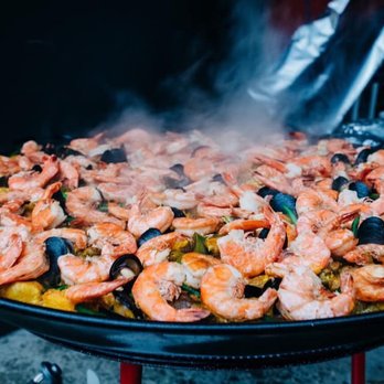 The Unlikely Spaniard - a large pan of food being cooked - Caterers Near Me The Unlikely Spaniard - a large pan of food being cooked - Caterers Near Me