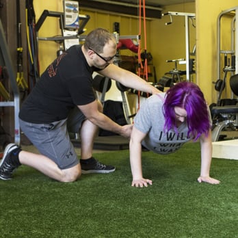 Bellevue Fitness Training - Helping a client to align their hips and back properly while doing an advanced TRX pushup - Trainers Near Me - Bellevue, Washington Bellevue Fitness Training - Helping a client to align their hips and back properly while doing an advanced TRX pushup - Trainers Near Me - Bellevue, Washington