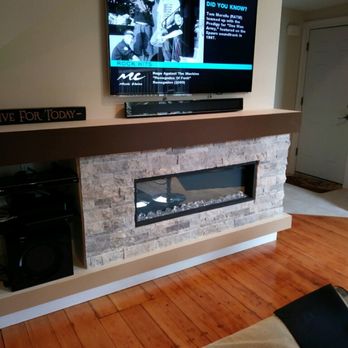 CE Smith Carpentry and Home Improvements - a flat screen tv mounted above a fireplace - Windows Installation Near Me CE Smith Carpentry and Home Improvements - a flat screen tv mounted above a fireplace - Windows Installation Near Me