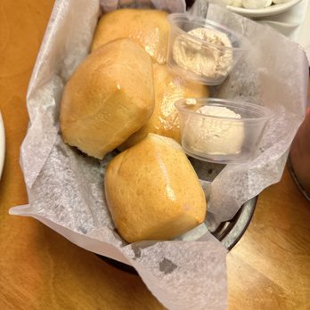 Texas Roadhouse - Multiple baskets of Texas Roadhouse famous buttery dinner rolls w/cinnamon butter sides! - Steakhouses Near Me - College Station, Texas