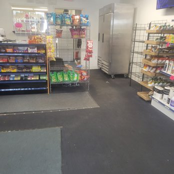Westside Flava's - Inside a convenience store, snack shelves display chips and candy, with a large stainless steel freezer in the background and additional shelving on the right. - Convenience Stores Near Me - Scranton, Pennsylvania
