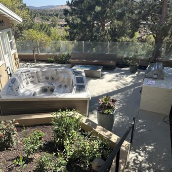 Echo Family Landscaping - A view of my backyard with retaining wall, built in BBQ, fire pit, floating bench and above-grade jacuzzi. - Landscaping Near Me Echo Family Landscaping - A view of my backyard with retaining wall, built in BBQ, fire pit, floating bench and above-grade jacuzzi. - Landscaping Near Me